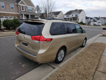 2011 Toyota Sienna XLE with navigation and JBL audio parked in a residential area.