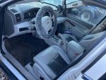 Interior view of a 2007 Jeep Grand Cherokee with a fluffy steering wheel cover and leather seats