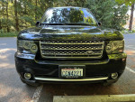 Front view of a 2012 Land Rover Range Rover Supercharged in black, showcasing its powerful design and features.