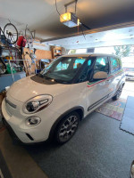 2014 Fiat 500L Trekking in garage, featuring unique Italian decals and modern alloy wheels.