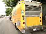 1997 Chevy P30 catering food truck parked, showcasing a vibrant yellow exterior and kitchen features.