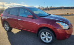 2011 Nissan Rogue SL AWD in maroon, featuring new tires and smooth ride, ideal for winter conditions.