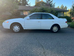1999 Toyota Camry CE in white, 135,000 miles, well maintained, with new timing belt and great fuel economy.