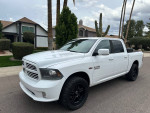 2013 Ram 1500 Sport 4WD pickup truck in white with black wheels parked in a residential area