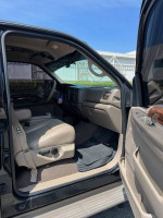 Interior view of a 2001 Ford Excursion Limited 7.3 Diesel with tan upholstery and well-maintained features.