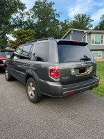 2007 Honda Pilot EX-L in fair condition, parked, showcasing its exterior and rear features.