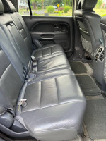 Back seat interior of a 2007 Honda Pilot EX, featuring leather seats and ample space.