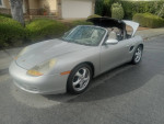 1998 Porsche Boxster convertible with automatic transmission parked on the street, 80k miles, silver color.
