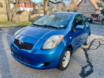 2007 Toyota Yaris hatchback in excellent condition, automatic, 62,000 miles, blue exterior, parked on a street.