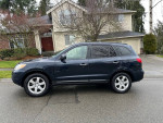 2007 Hyundai Santa Fe Limited parked on a residential street, showcasing its black exterior and sleek design.