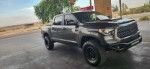 2018 Toyota Tundra TRD Sport 4x4 with upgrades, showcasing new rims and tires, parked in a scenic location.