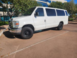 2012 Ford E-350 XLT passenger van with clean interior and cold AC, parked outside.