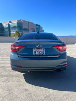 2016 Hyundai Sonata SE FWD in good condition, low mileage, parked outdoors with a clear blue sky