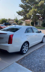 Side view of a well-maintained 2013 Cadillac ATS Performance RWD parked on a residential street.
