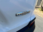 Close-up of the 'Latitude' badge on a 2019 Jeep Cherokee Latitude FWD parked on a driveway.