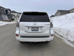 Rear view of a 2015 Lexus GX 460 4WD parked on a snowy street, showcasing its clean design and license plate.