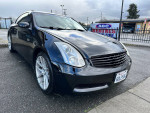 2005 Infiniti G35 Coupe in black, fully loaded with aftermarket exhaust and rims, parked on a street.