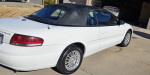 2006 Chrysler Sebring Convertible in white, showcasing its sleek design and new black top.