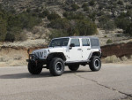 2007 Jeep Wrangler in excellent condition with upgrades, parked on a rugged terrain