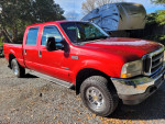 2002 Ford F250 Superduty XLT Crew Pickup Truck in Red with Garage Background