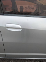 Silver 2013 Honda Fit passenger door with minor scratches and custom mat, great for hauling cargo.