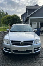 2005 Volkswagen Touareg V8 AWD parked in the Beebe Bridge area, showcasing its sleek front design.