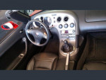 Interior view of a 2006 Pontiac Solstice with leather seats, dashboard, and gear shift.