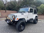 1999 Jeep Wrangler Sahara 4WD in excellent condition with off-road features and custom tires