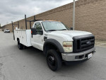 2009 Ford F450 utility bed work truck with low miles parked on the street