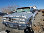 1991 Chevrolet Suburban 1500 for sale, silver with a damaged windshield, suitable for restoration or original use.