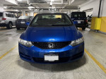 Blue 2010 Honda Civic EX front view in parking garage, featuring clean design and well-maintained condition
