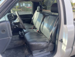 Interior view of a 2002 GMC Sierra 1500 pickup truck with black leather seats.