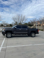 2015 Chevrolet Silverado 1500 Z71 LT in a parking lot, featuring premium wheels and a sleek design.