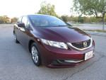 2014 Honda Civic LX Sedan in excellent condition with 94,000 miles parked outdoors