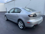 Silver Mazda 3 sedan, low mileage at 102,000 miles, available for sale in great condition.