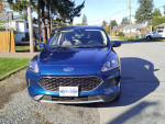2020 Ford Escape SE FWD in blue, showcasing stylish design and modern features, parked on a residential street.