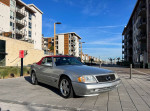 2000 Mercedes-Benz SL500 with burgundy soft top parked in urban setting, low mileage and clean title.
