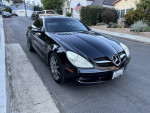 2008 Mercedes-Benz SLK350 convertible in black parked on the street, showcasing sporty design and clean exterior.