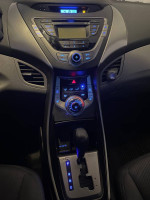 Interior dashboard and controls of a 2013 Hyundai Elantra featuring an intuitive design and modern technology.