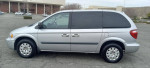 2006 Chrysler Town and Country van in silver, showing side view and new tires, great condition with low mileage.