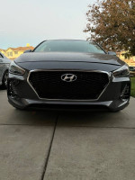 Front view of a 2018 Hyundai Elantra GT with alloy wheels, showing its sleek design and salvage title