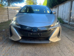 Front view of a 2021 Toyota Prius Prime plug-in hybrid with a clean exterior and modern design.