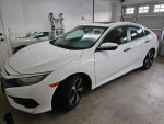 2016 Honda Civic Touring in white, showcasing sleek design and features like premium wheels and sunroof.