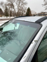 Close-up of the roof and windshield of a 2009 Hyundai Santa Fe with minor paint wear.