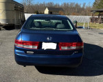 2003 Honda Accord in blue with a new inspection, showing minor wear and tear, parked outdoors.