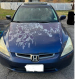 2003 Honda Accord with paint damage on the hood and leather interior, showcasing its 76,000 miles and sunroof.