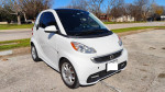 2015 Smart Fortwo Electric Drive EV Hatchback in white, parked on a sunny day, ideal for city driving