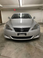 Front view of a silver 2007 Lexus IS 250 RWD in a garage, featuring clean lines and sleek design.