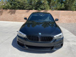 Front view of a black 2018 BMW 540d xDrive with low mileage parked outdoors.