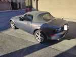 2007 Mazda MX-5 Sport in gray with a black convertible top parked in a driveway